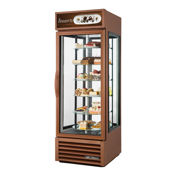 A True black refrigerated glass door merchandiser with a variety of food on display.