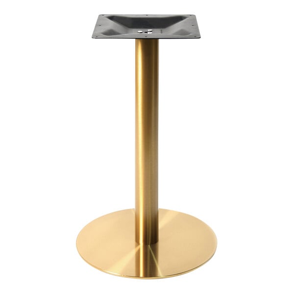 A gold cylindrical table base with a black metal plate.