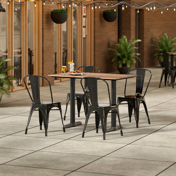 Lancaster Table & Seating Excalibur 27 1/2" x 47 3/16" Rectangular Textured Yukon Oak Standard Height Table with 4 Alloy Series Black Outdoor Cafe Chairs