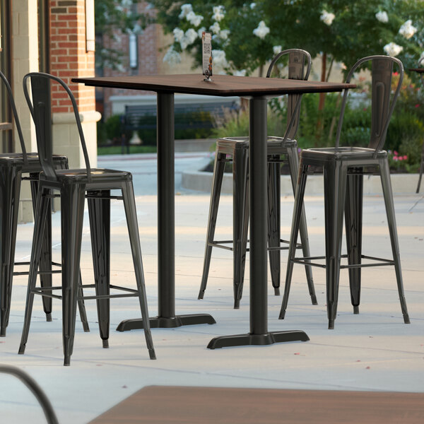 Lancaster Table & Seating Excalibur 27 1/2" x 47 3/16" Rectangular Textured Walnut Bar Height Table with 4 Alloy Series Black Outdoor Cafe Barstools