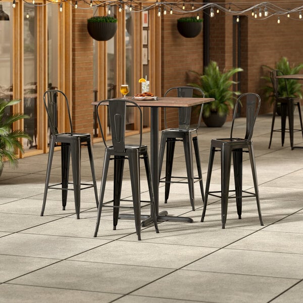 Lancaster Table & Seating Excalibur 36" x 36" Square Textured Yukon Oak Bar Height Table with 4 Alloy Series Black Outdoor Cafe Barstools