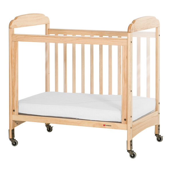 Foundations Next Gen Serenity 24" x 38" Natural Compact Fixed-Side Wood Crib with SafeSupport Frame, 3 ClearView Panels, and 3" InfaPure Mattress