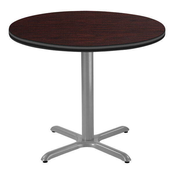National Public Seating 30" Round Mahogany Standard Height Cafe Table with Particleboard Core, X Base, and Gray Frame