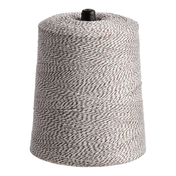 A cone of brown and white variegated polyester cotton blend baker's twine.
