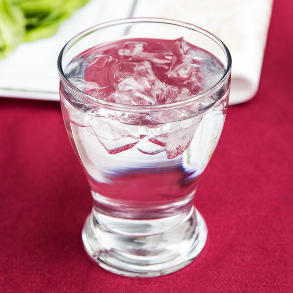 A glass of water with ice cubes on a white background.