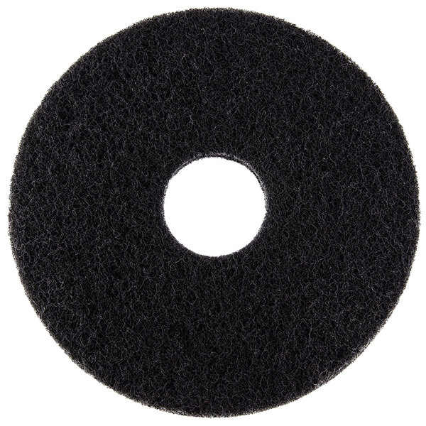 A black Scrubble 10" stripping floor pad with a hole in the middle.