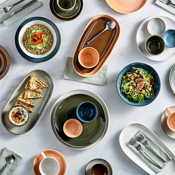 A table with Acopa Highlands white china bowls and Birch white china plates on it.