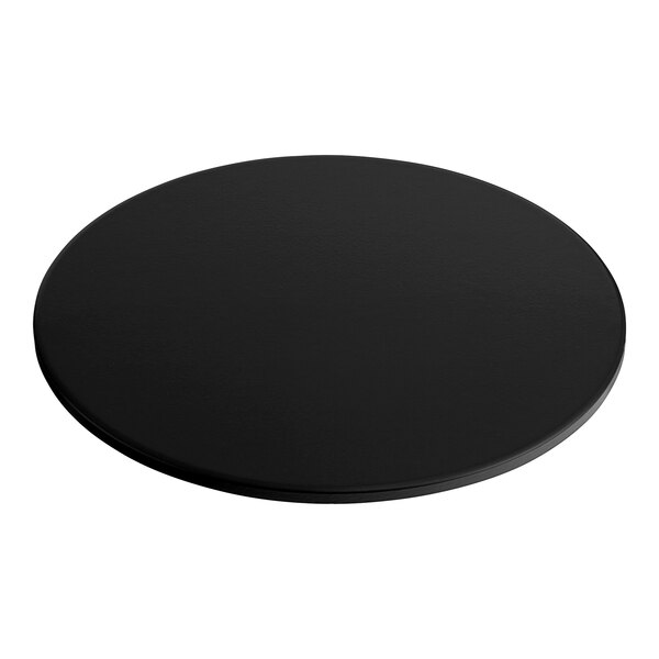 A black round Solwave pizza stone on a white table.