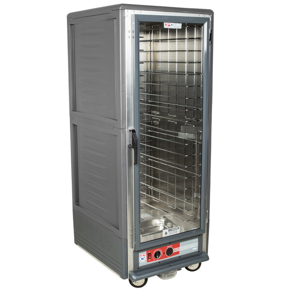 A large gray metal Metro C5 heated holding cabinet with shelves and a clear door.