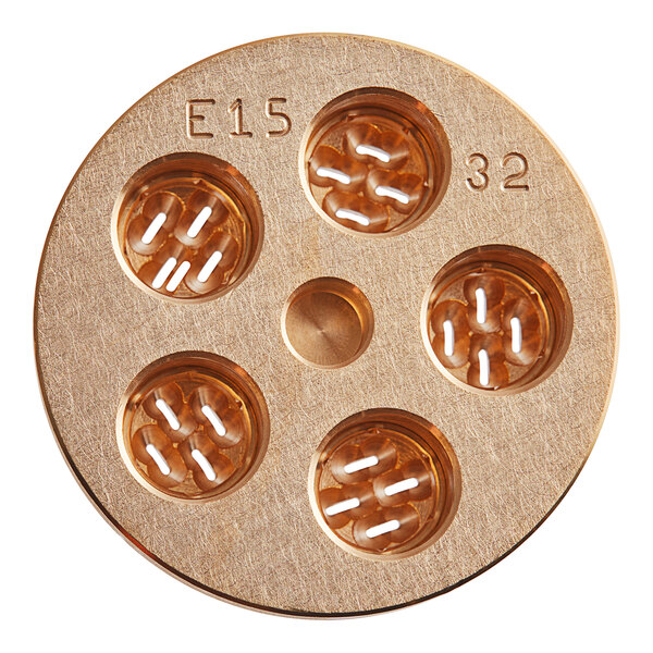 A circular gold pasta die with four holes in it.