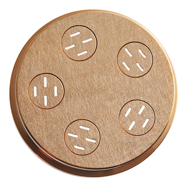 A round metal pasta die with circular holes in it.