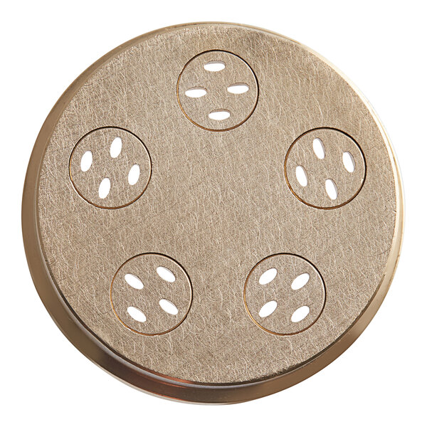 A circular brass plate with holes in it.