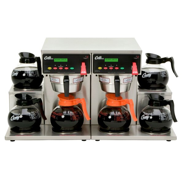 A Curtis twin coffee brewer with two coffee pots on top.