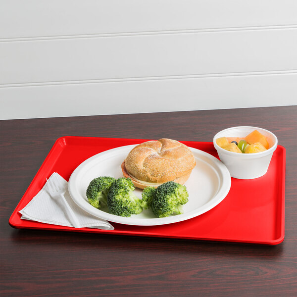 A red Cambro dietary tray with food on it.