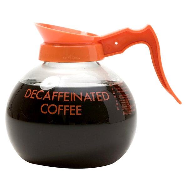 A Curtis Crystalline decaf coffee decanter with an orange handle.