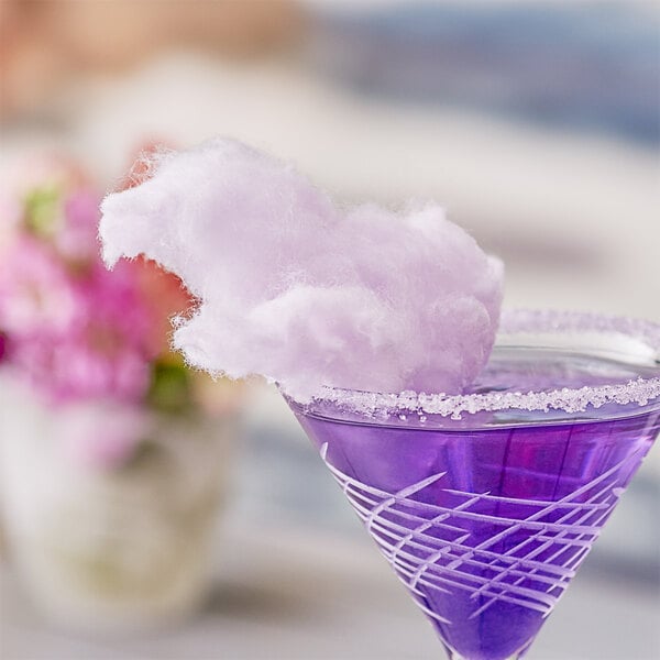A purple drink in a Great Western 1/2 gallon carton with cotton candy on top.