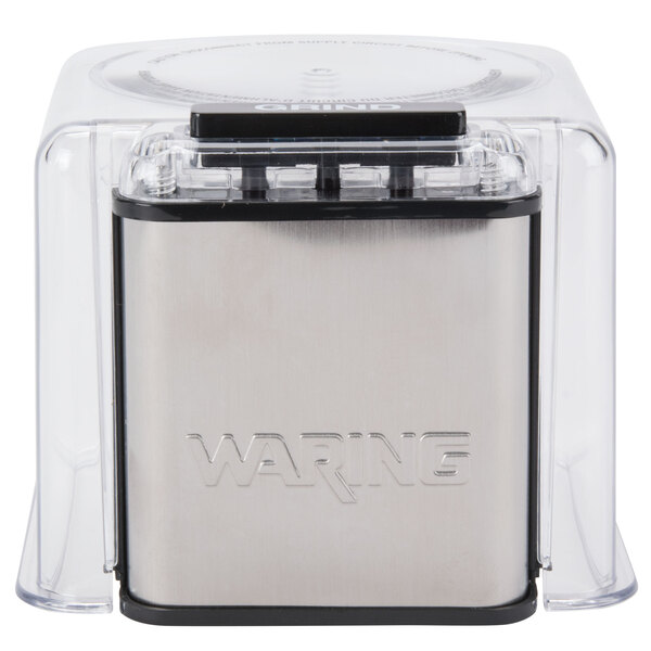 A clear plastic cover for a silver and black Waring spice grinder.