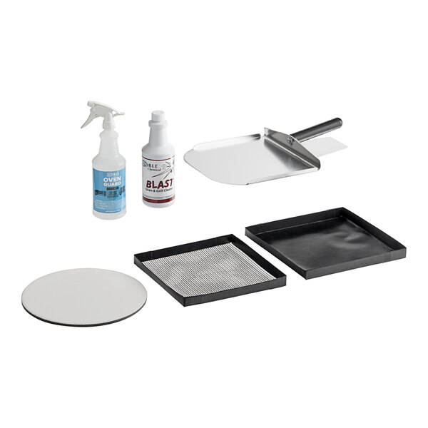 A black square box with a white circle and black lettering on the lid, containing a metal tray, a sponge, and a bottle.