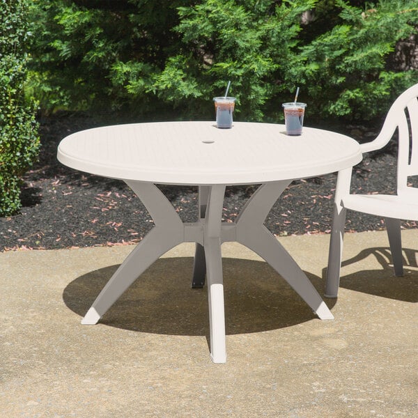 Grosfillex US526766 Ibiza 46" Sandstone Round Resin Pedestal Table with Umbrella Hole