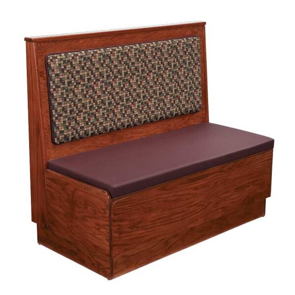 An American Tables & Seating wood wall bench with a purple cushion on the seat and back.