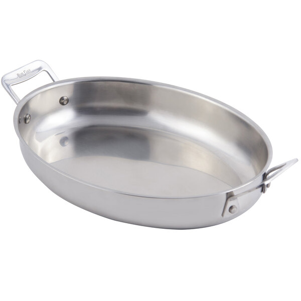 A stainless steel Bon Chef oval au gratin pan with handles.