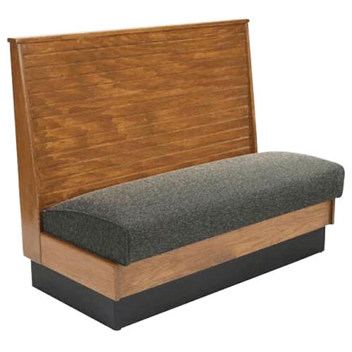 A wooden booth with a grey cushion.