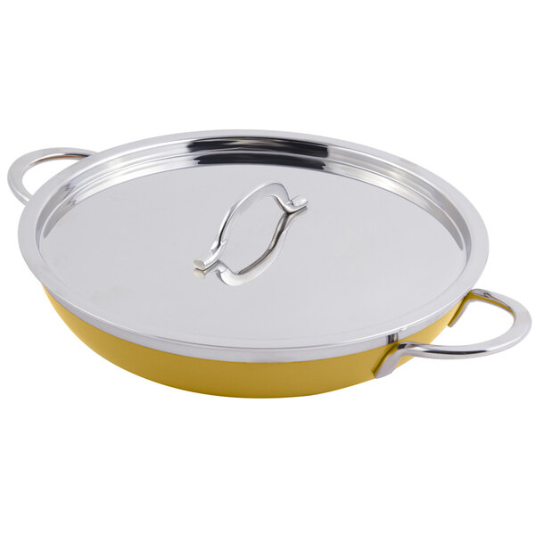 A yellow Bon Chef saute pan with double handles and a silver lid.
