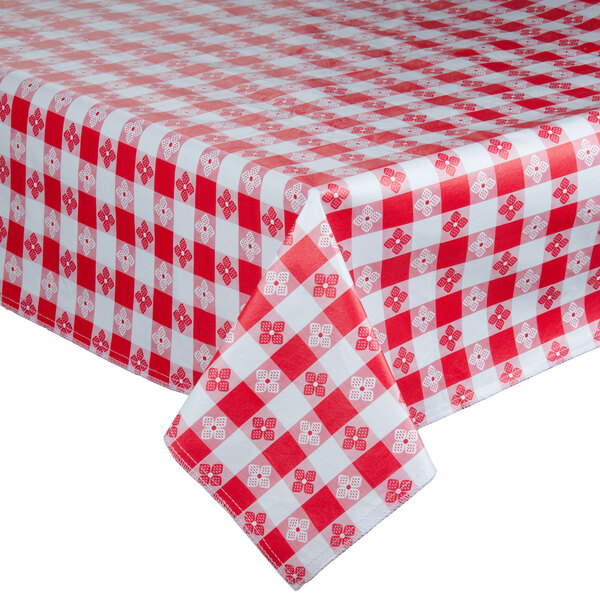 A red and white checkered Intedge vinyl table cover on a table.