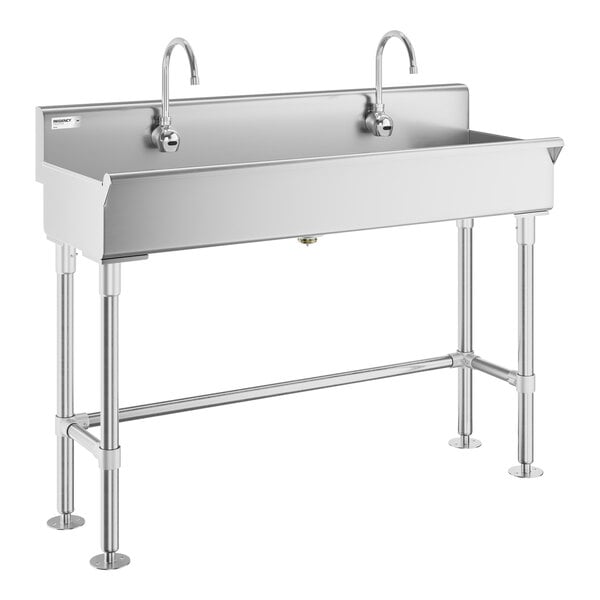 A stainless steel double-station sink with two gooseneck faucets and four sturdy legs.