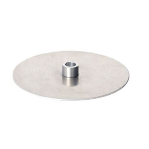 A metal disc with a hole on a table.