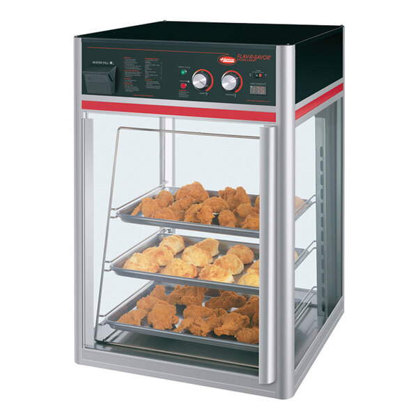 A Hatco Flav-R-Savor countertop hot food display with a tray of baked goods.