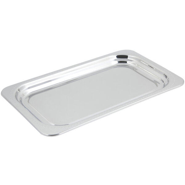 A stainless steel rectangular food pan with a Bolero design border.