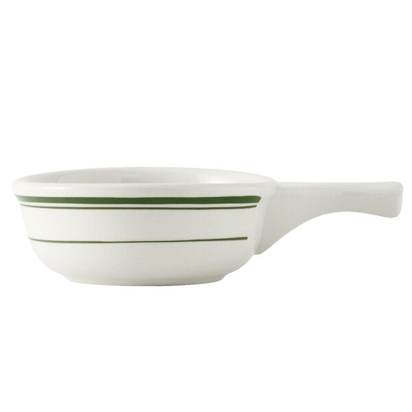 A white French casserole bowl with green stripes and a handle.