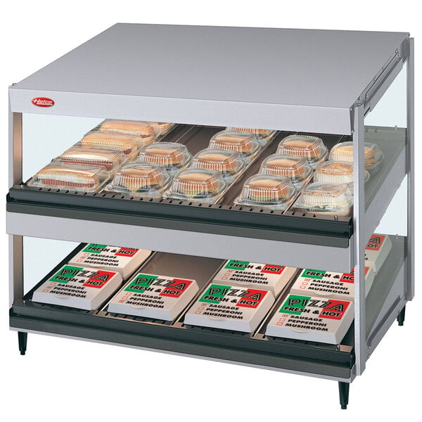 A Hatco countertop food display case with trays of food in it.