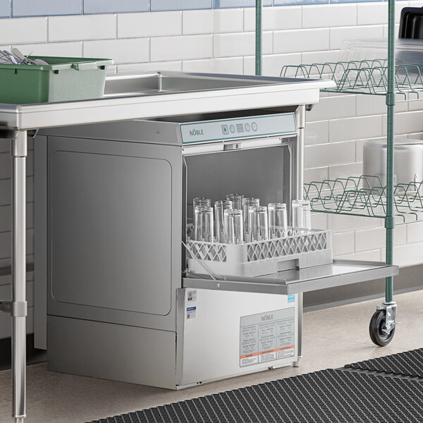 A Noble Warewashing undercounter dishwasher with glasses inside.