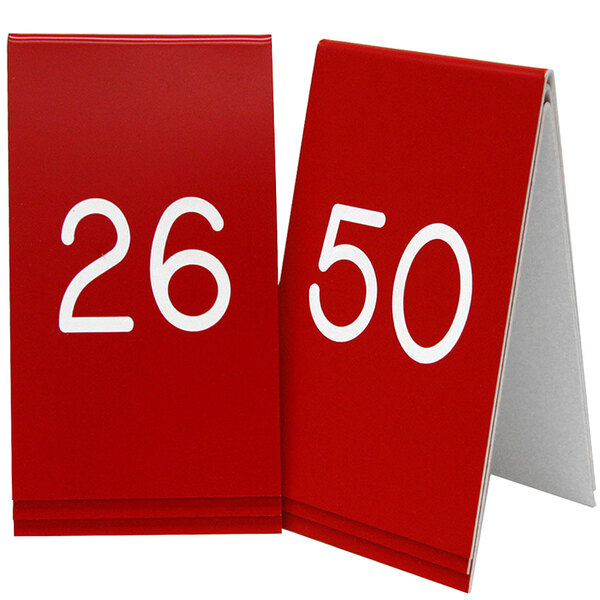 Two red Cal-Mil table tents with white engraved numbers 26 to 50.