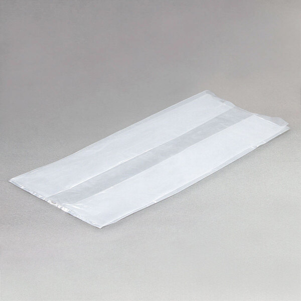 A white plastic LK Packaging food bag on a gray surface.