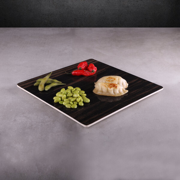 An Elite Global Solutions square faux zebra wood melamine serving board with food on it on a table.