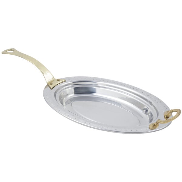 A Bon Chef stainless steel food pan with a long brass handle and a laurel design.