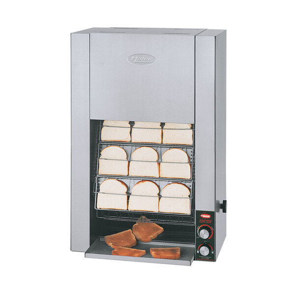 A Hatco vertical conveyor toaster with slices of bread in it.