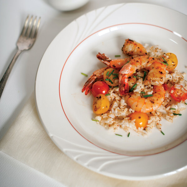 A Tuxton Monterey plate with shrimp, rice, and tomatoes.