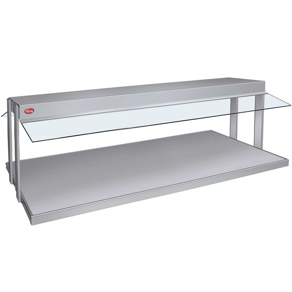 A white Hatco countertop buffet warmer with a glass surface over a white shelf.