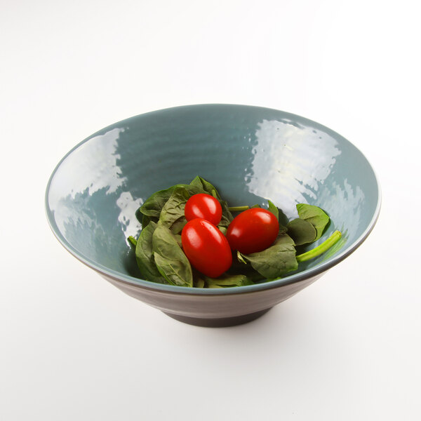A Elite Global Solutions Pebble Creek Abyss-colored melamine bowl filled with tomatoes and spinach leaves.
