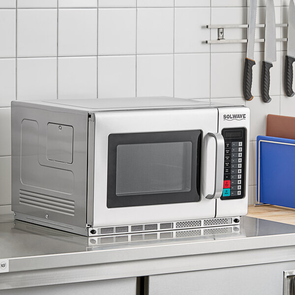 A Solwave commercial microwave on a counter with a glass door.