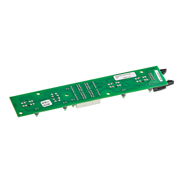 A green Noble Warewashing control board interface with black and white text and silver metal balls.