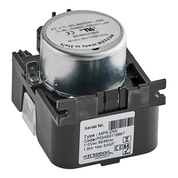 A black and silver Noble Warewashing sanitizer dosing pump with a white label.