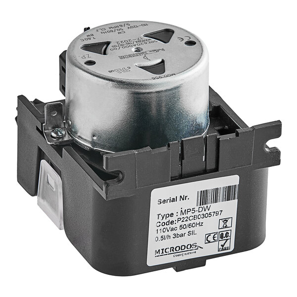 A close up of a black and silver Noble Warewashing rinse aid dosing pump.