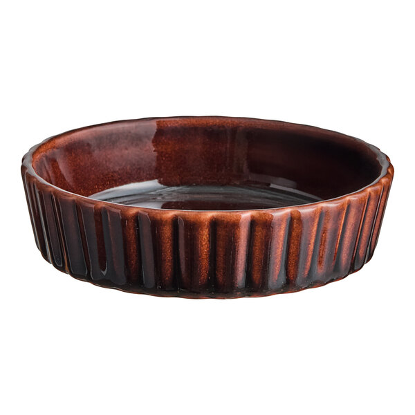 An Acopa Keystone chestnut porcelain souffle dish with a rippled design.