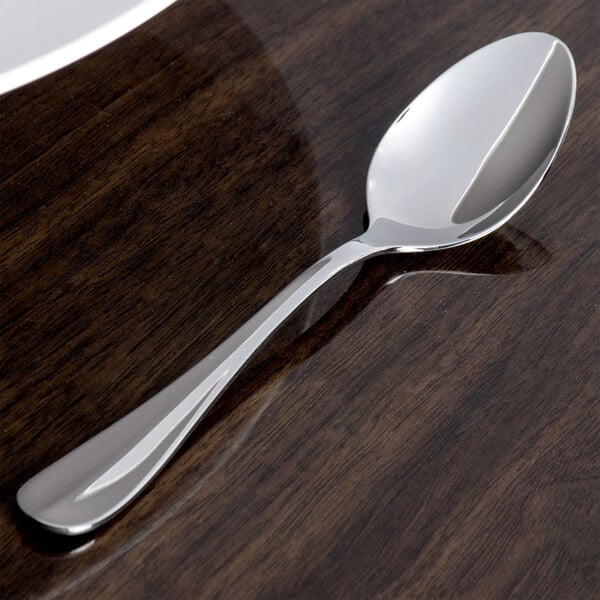 A Oneida Bague stainless steel teaspoon on a table.