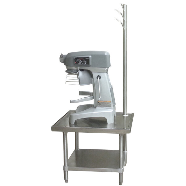 An Advance Tabco stainless steel mixer table with a machine on it.